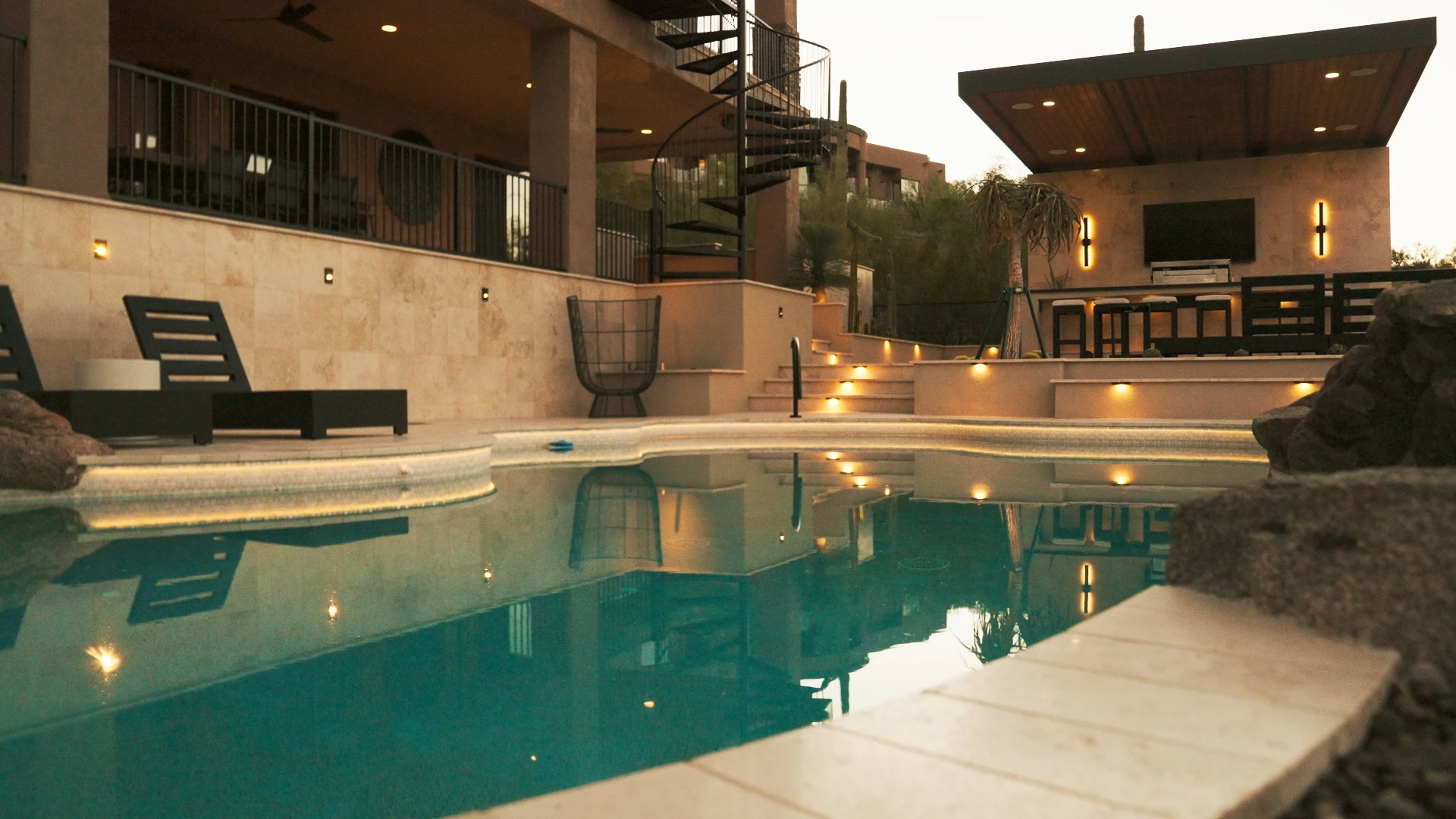 Pool and terrace lit at dusk