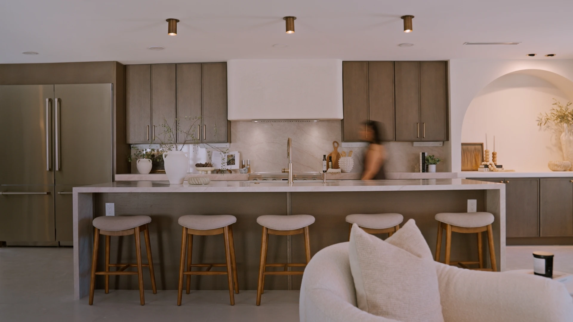 Kitchen with a long island and wooden stools
