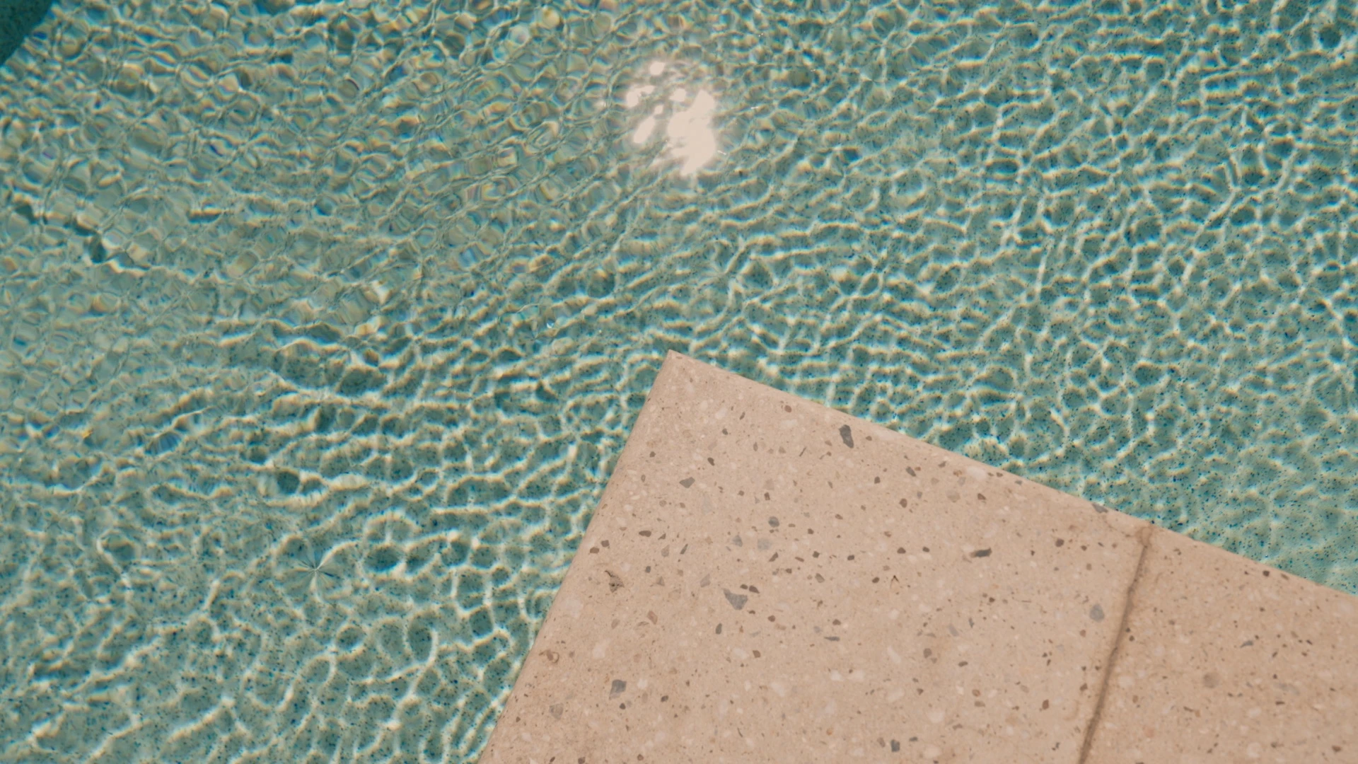Pool water and stone coping from above