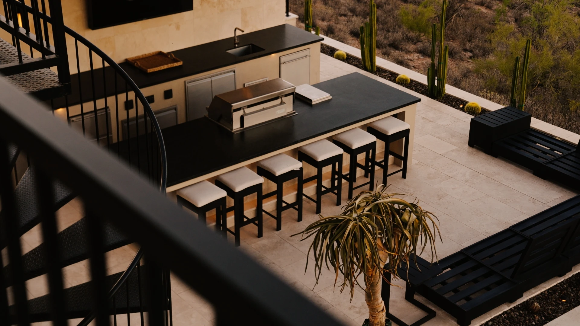 Outdoor kitchen and bar seen from the spiral stair